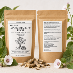 Two stand-up pouches of Farmer Soul Organic Marshmallow Root herbal tea are shown front and back on a light surface, with marshmallow roots, green leaves, and white flowers around them.