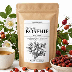 A kraft paper stand-up pouch labeled Farmer Soul Organic Rosehip Rosa canina stands centered on a white background, surrounded by rosehip berries, rosehips in a bowl, rosehip blossoms, and a cup of tea.
