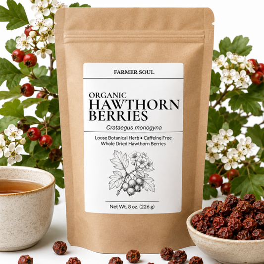 A stand-up pouch of Farmer Soul Organic Hawthorn Berries centered on a white background, surrounded by green leaves, white flowers, red berries, a cup of tea, and a bowl of loose dried berries.